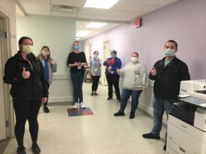 staff in PPE standing in hallway of the recovery hub