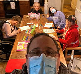 adult residents coloring around a table