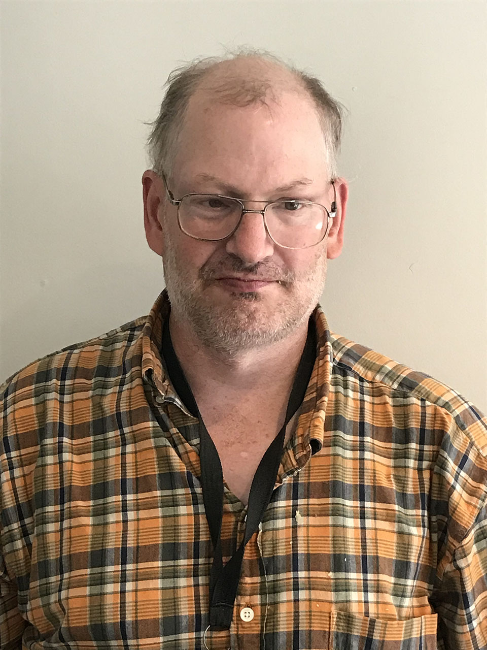 Photo of man in yellow plaid shirt