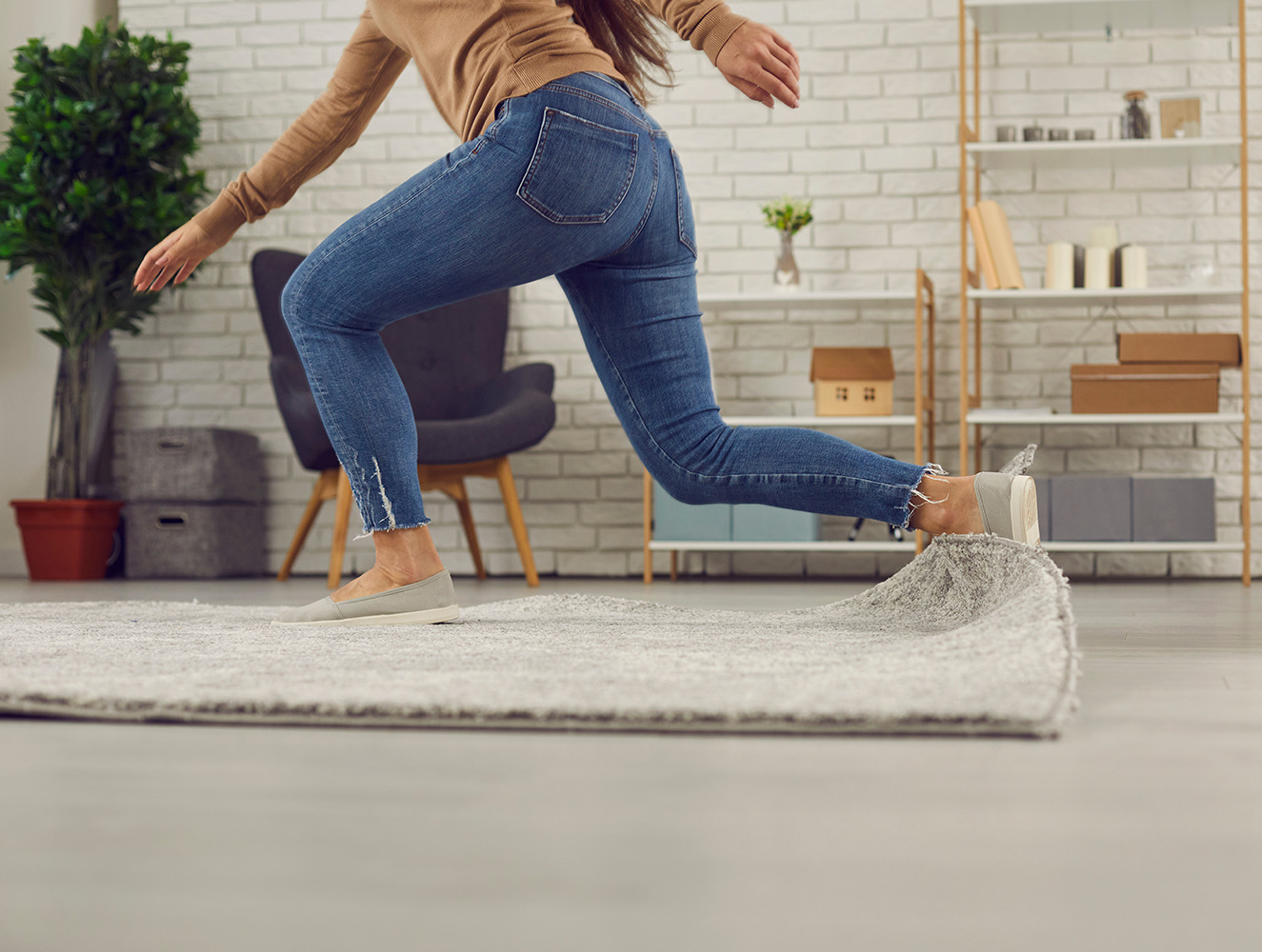 woman tripping over corner of area rug